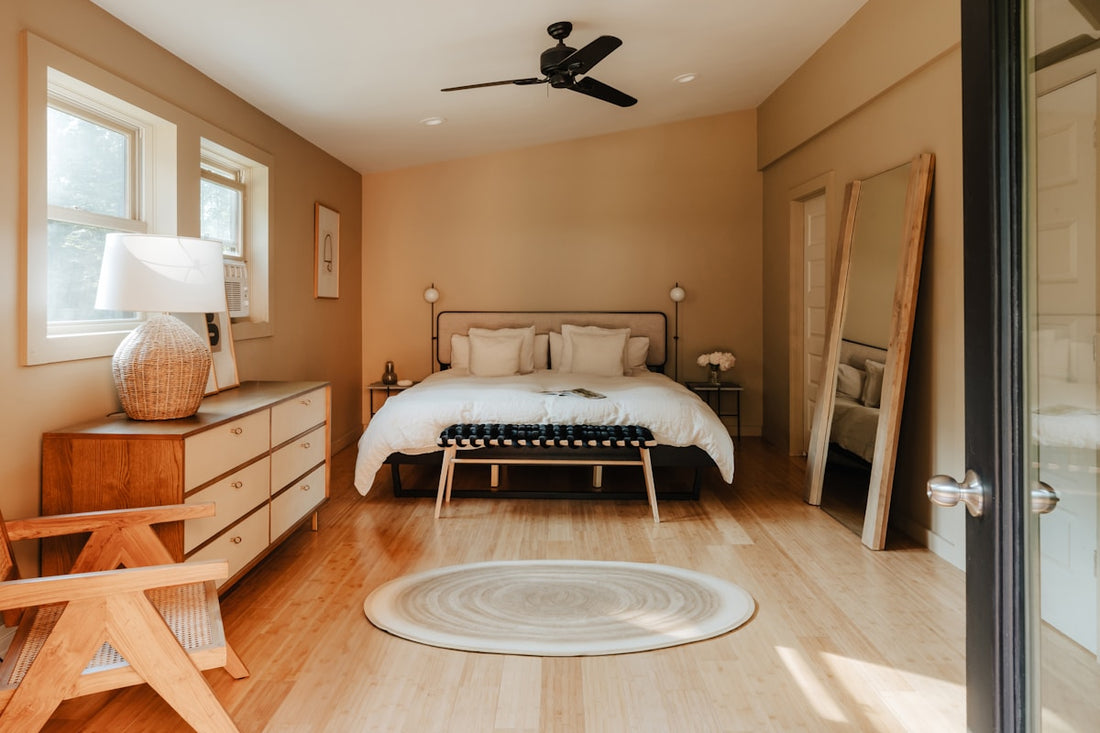 Bright summer bedroom with a ceiling fan and window air conditioner